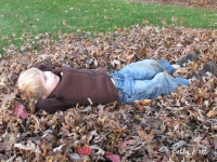Boy lying in leaves